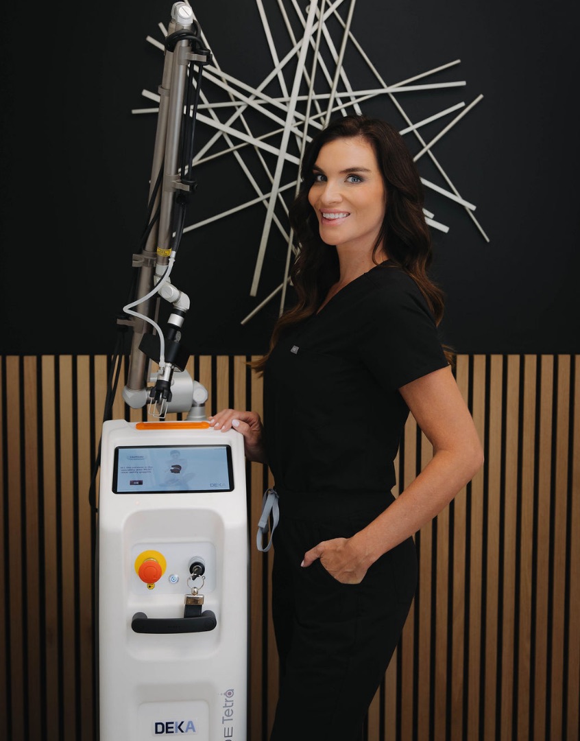 Salt Spa provider standing beside the DEKA Tetra CO2 laser