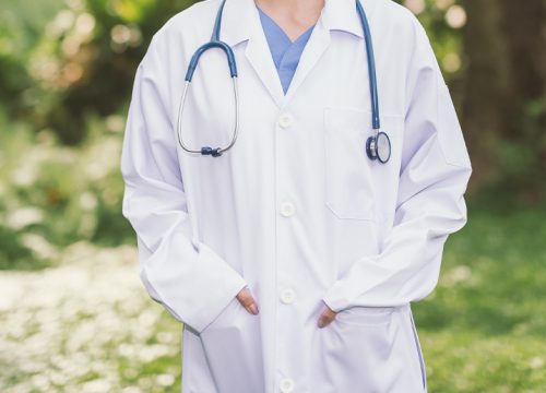 Doctor with a closer shot of his lab coat and stethoscope
