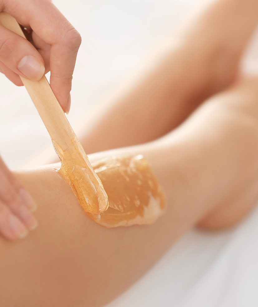 Photo of wax being applied to a woman's leg